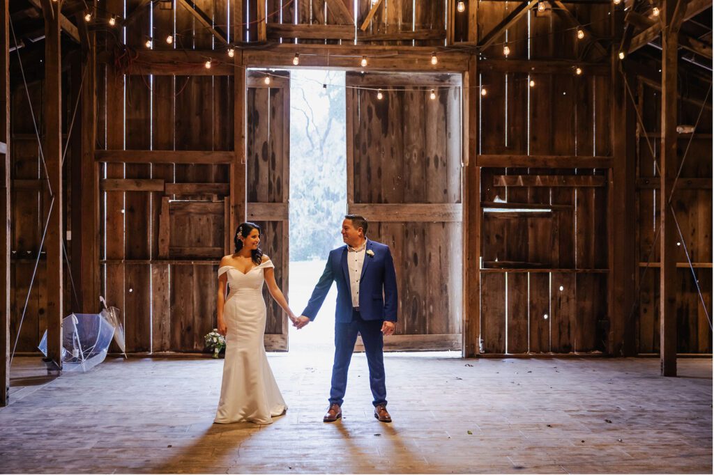 Bride and groom portraits in a barn at Halter Ranch Winery