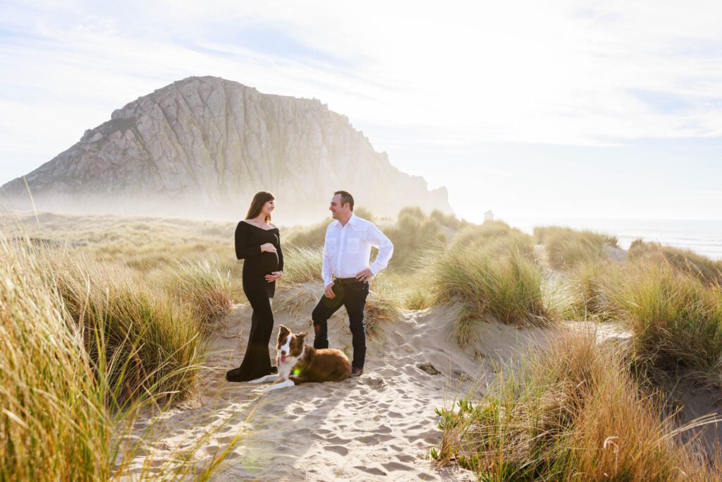 Maternity photo in the san dunes with morro rock in background