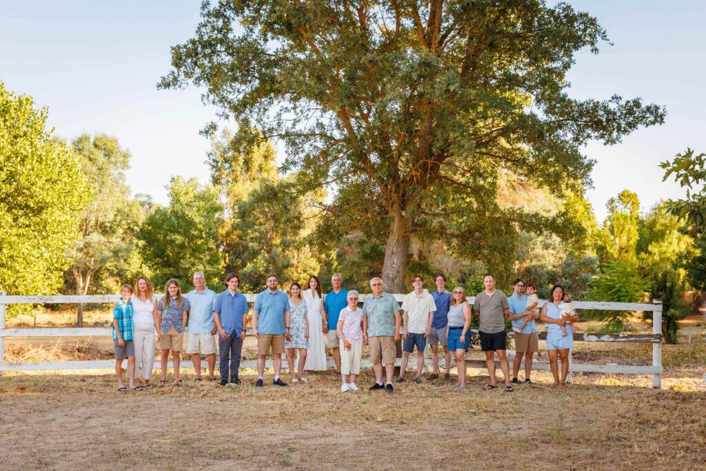 Large extended family portrait beneath an oak tree at a Paso Robles vacation rental.