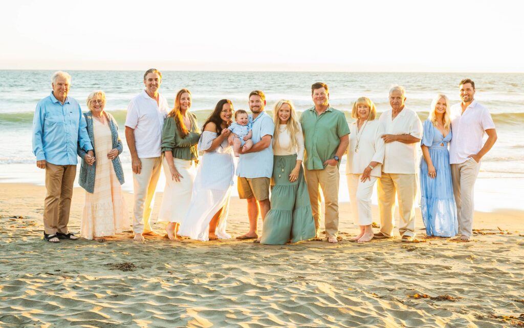 Large extended family portrait together on the beach in Cayucos, California.