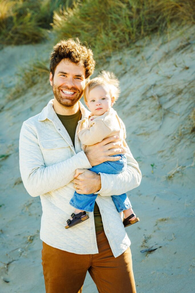 Father holding his baby during a family portrait session in Morro Bay