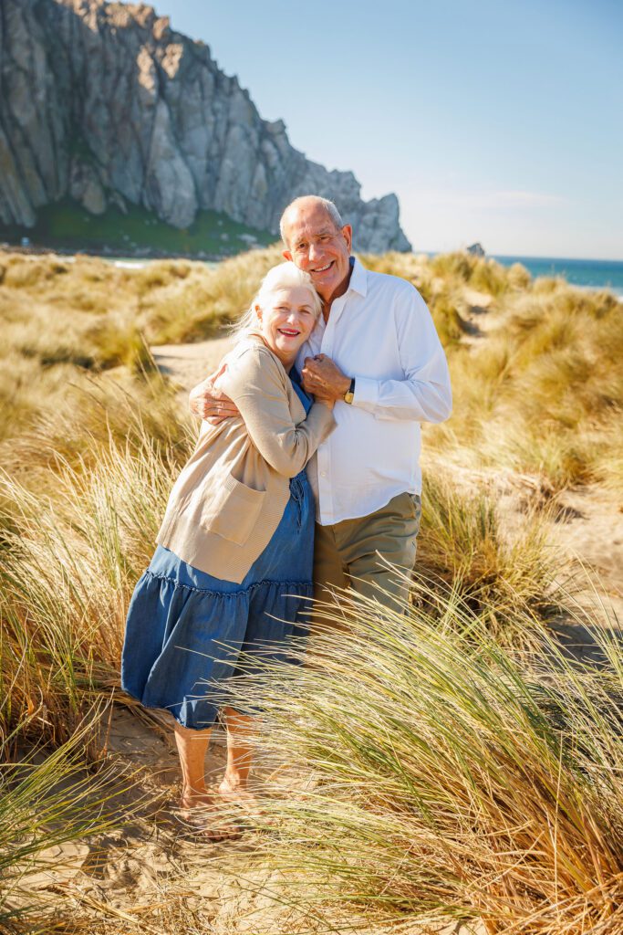 Grandparents photographed together among the beach grasses in Morro Bay