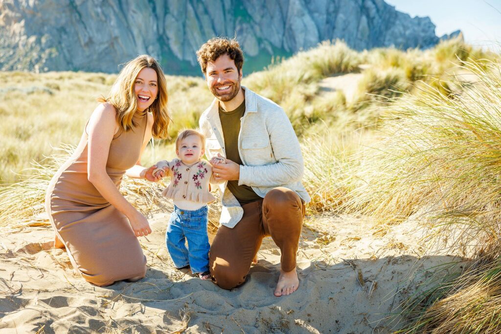 Parents and their baby photographed with Morro Rock in the background